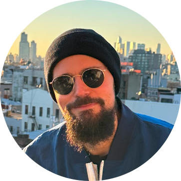 Javier Casaudoumecq, bearded, in a beanie and sunglasses on a rooftop